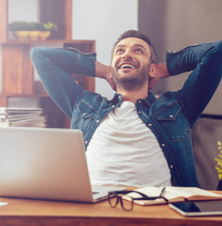 Guy Setting On A Desk