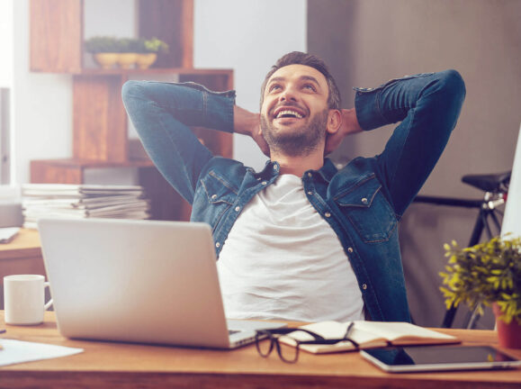 Guy Setting On A Desk